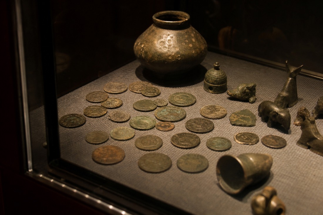 Carved jade and rock crystal objects in a display case at The David Collection