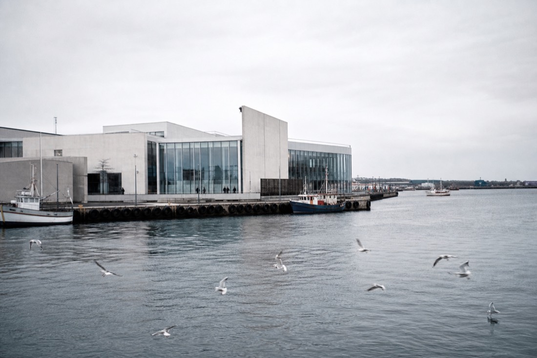 Grand cultural-history museum interior in Copenhagen with visitors moving between exhibition halls